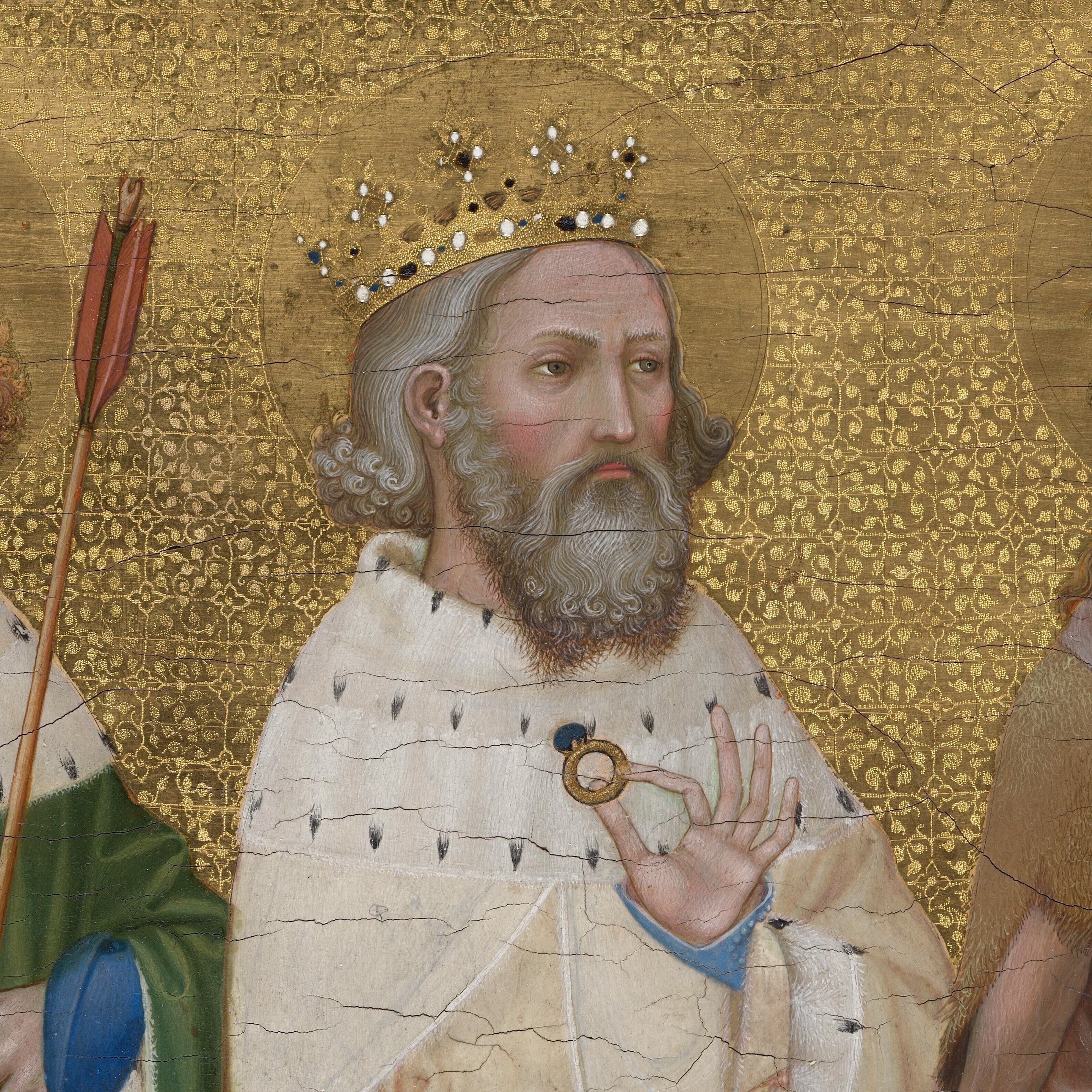 Saint Edward wearing a crown and an ermine-lined cloak, holding a ring, in a detail of the medieval Wilton Diptych.