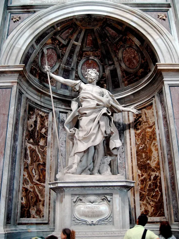 Longinus: marble statue of a man with outstretched arms in a church niche