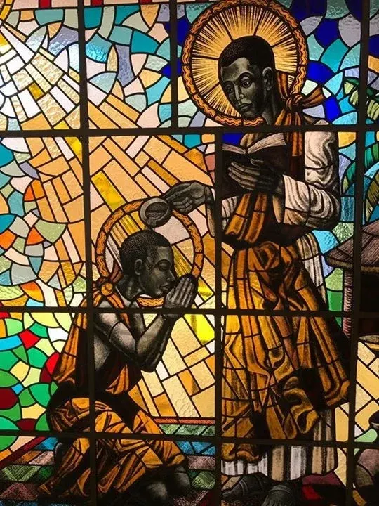 Kizito: mosaic of a standing figure with a kneeling child
