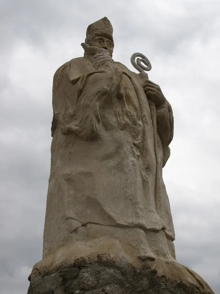 Trophimus of Arles: weathered outdoor stone statue of a bishop holding a staff