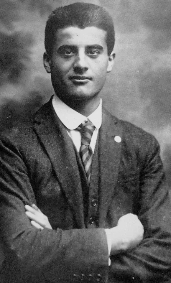 Pier Giorgio Frassati: black-and-white photograph of a young man in a suit with arms folded