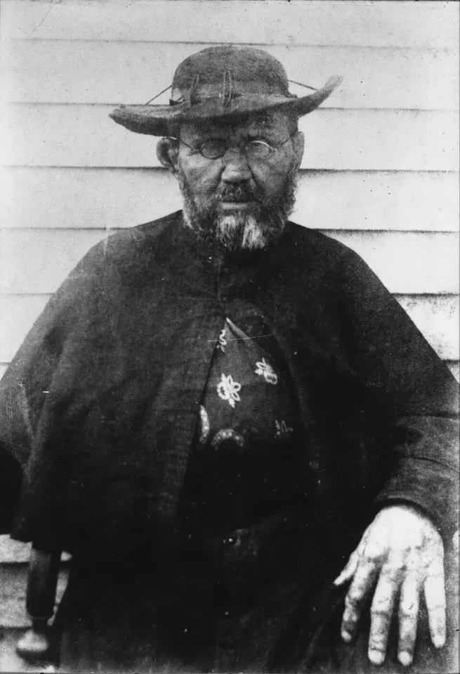 Damien de Veuster of Molokai: black-and-white photograph of a bearded priest wearing a broad hat
