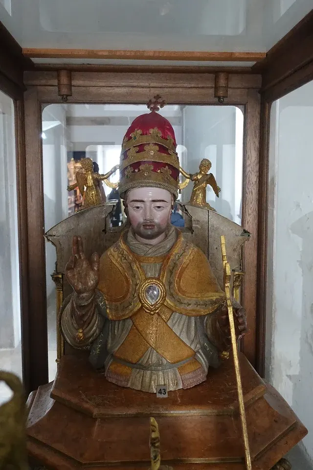 John I: painted bust of a pope wearing an ornate tiara, in a glass case