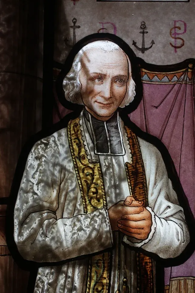 John Vianney: painted statue of an elderly priest in ornate vestments