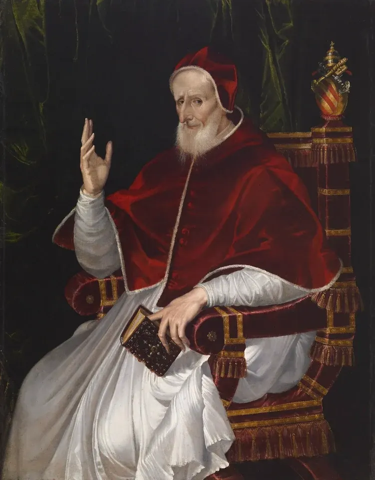 Pius V: painting of a seated pope in white and red robes raising a hand in blessing